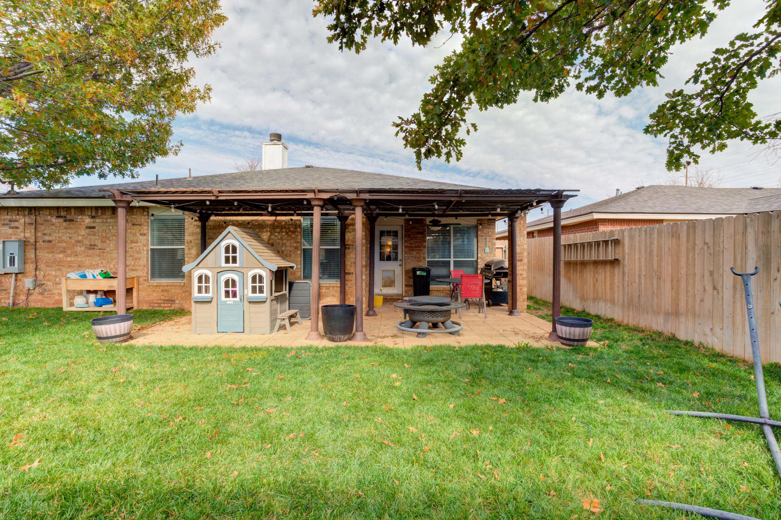 1607 79th Street Lubbock, TX 79423 - Photo 50 of 53 a view of a house with backyard porch and sitting area