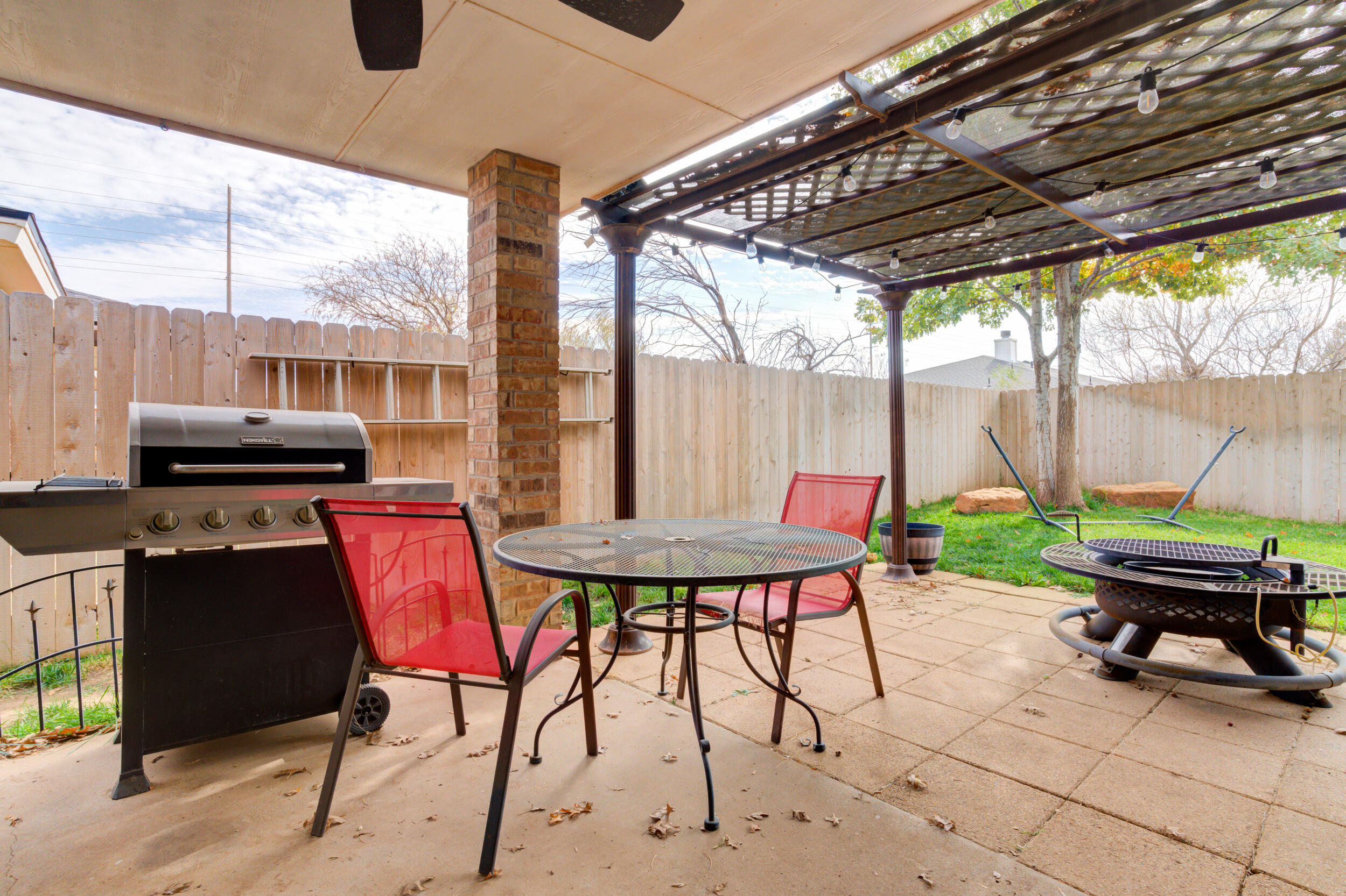 1607 79th Street Lubbock, TX 79423 - Photo 53 of 53 a backyard of a house with a table and chairs