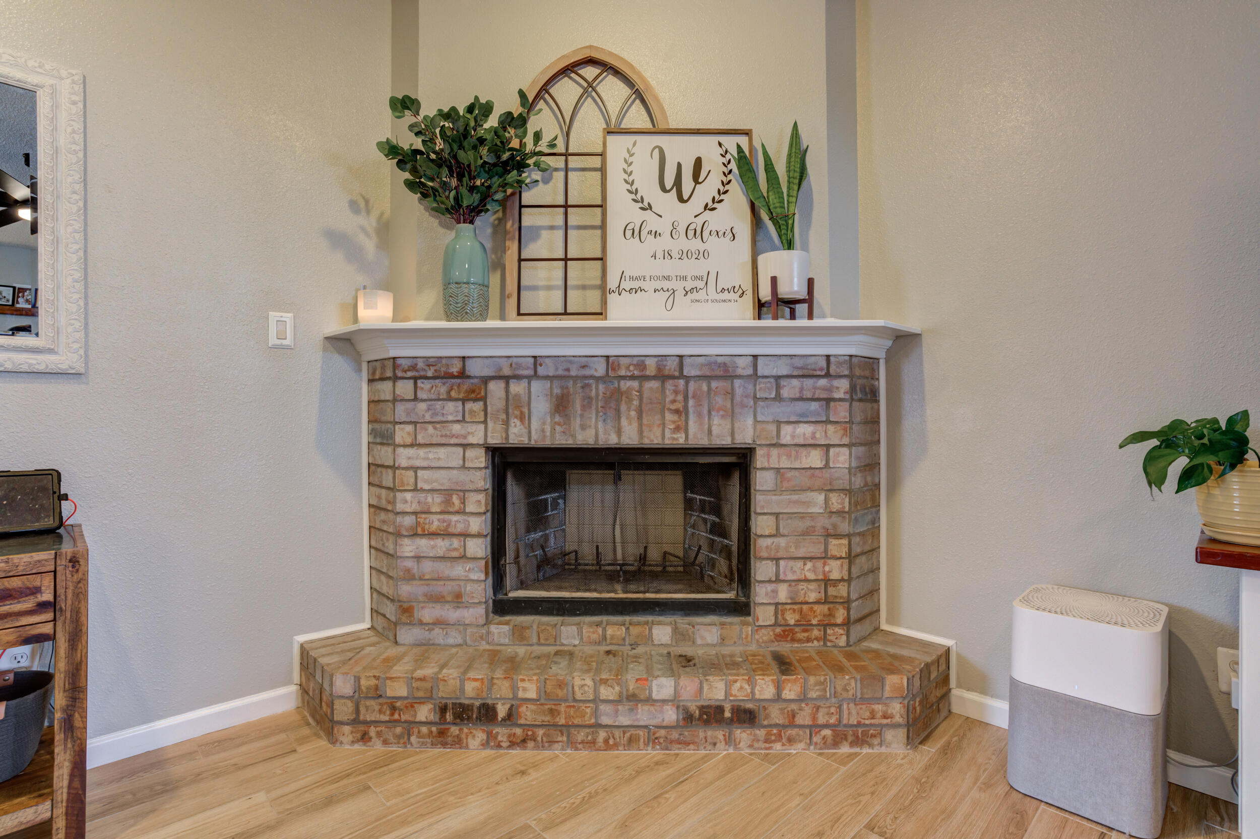 1607 79th Street Lubbock, TX 79423 - Photo 9 of 53 a living room with a fireplace and wooden floor
