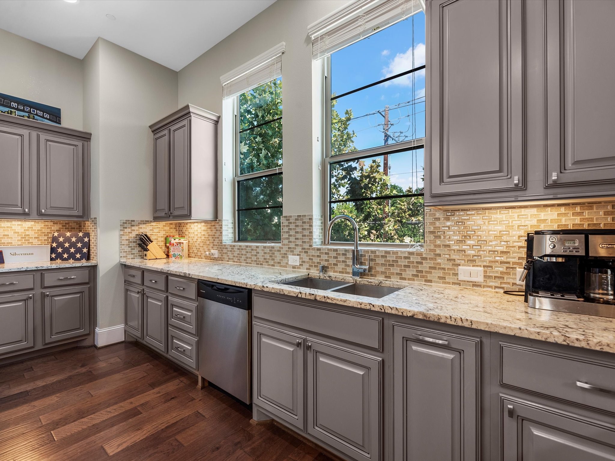 5467 Larkin Street Houston, TX 77007 - Photo 10 of 33 a kitchen with stainless steel appliances granite countertop a sink a stove cabinets and wooden floor