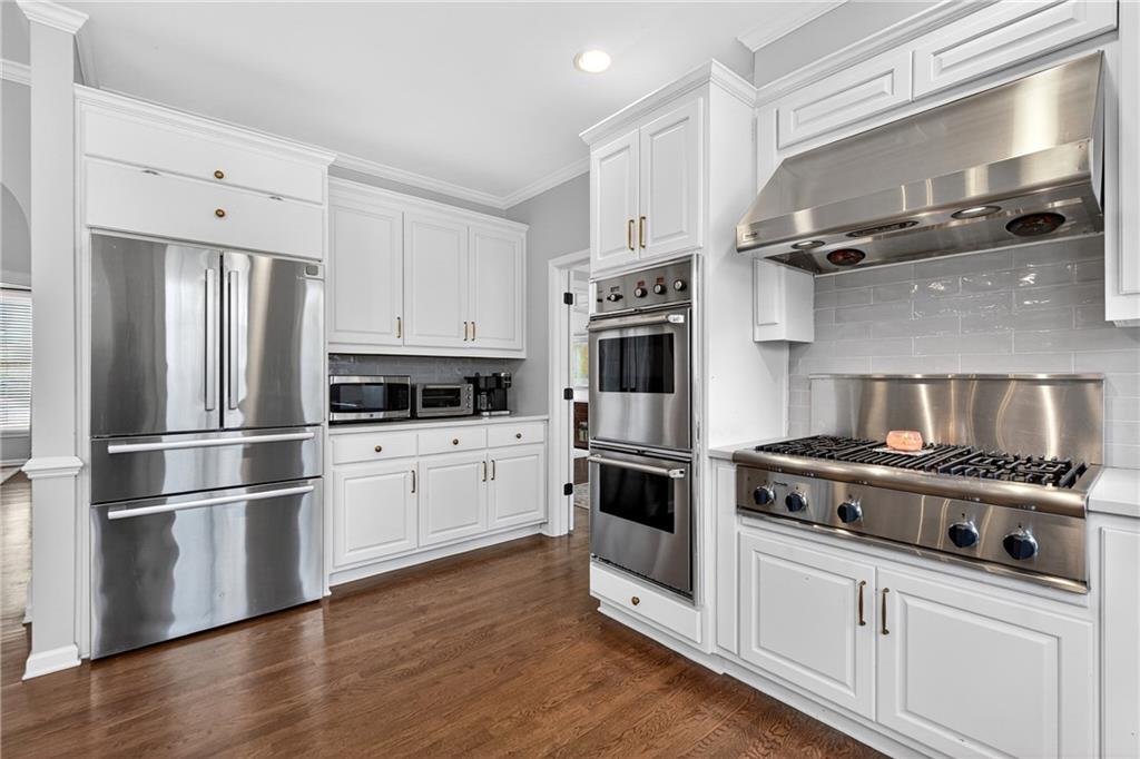 14325 Morning Mountain Way Milton, GA 30004 - Photo 11 of 66 a kitchen with cabinets stainless steel appliances and wooden floor