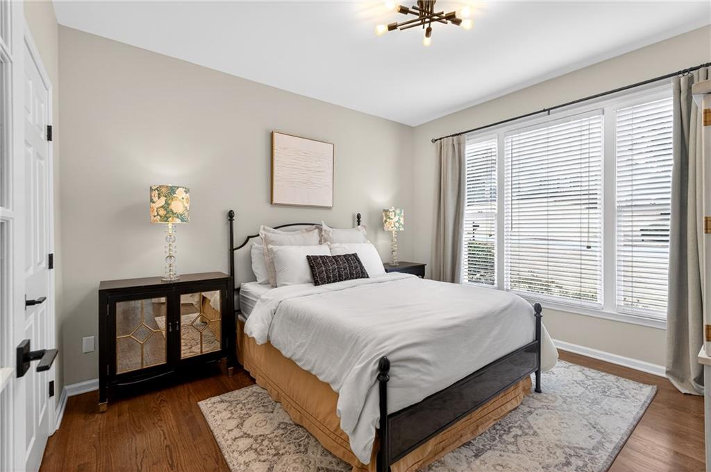 14325 Morning Mountain Way Milton, GA 30004 - Photo 22 of 66 a bedroom with a bed and a chandelier