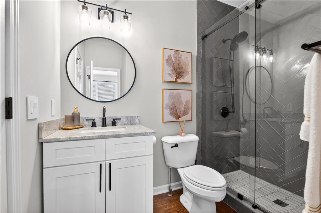 14325 Morning Mountain Way Milton, GA 30004 - Photo 24 of 66 a bathroom with a toilet sink vanity granite and shower