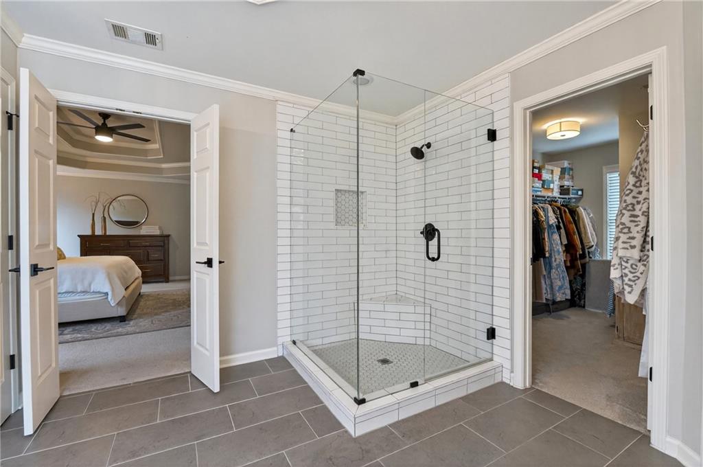 14325 Morning Mountain Way Milton, GA 30004 - Photo 31 of 66 a bathroom that has a glass shower door