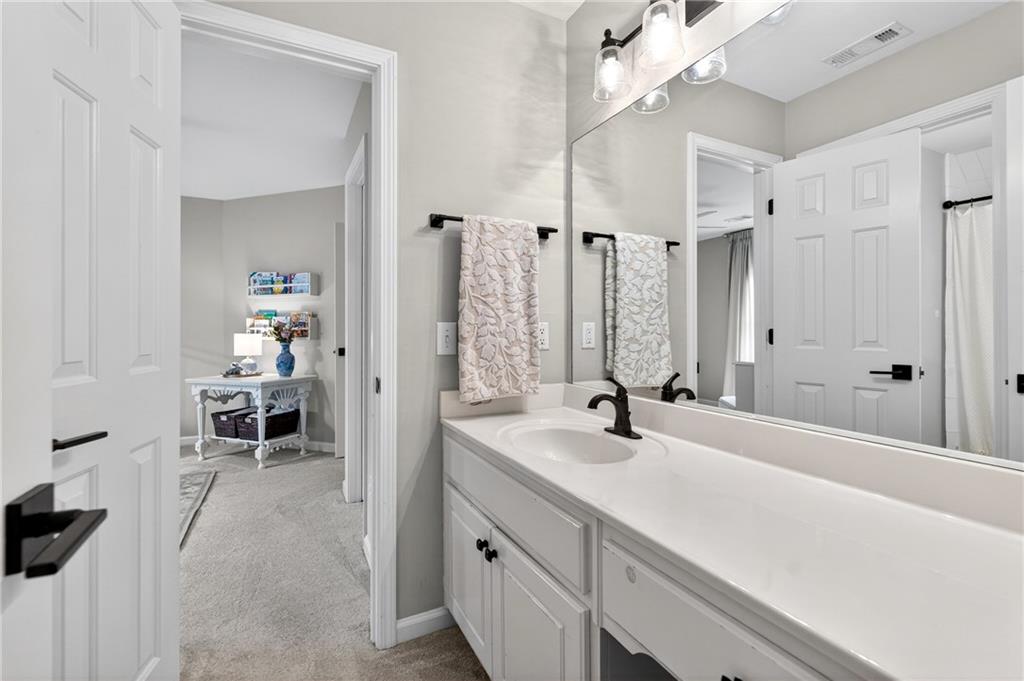 14325 Morning Mountain Way Milton, GA 30004 - Photo 34 of 66 a bathroom with a double vanity sink a mirror and a shower