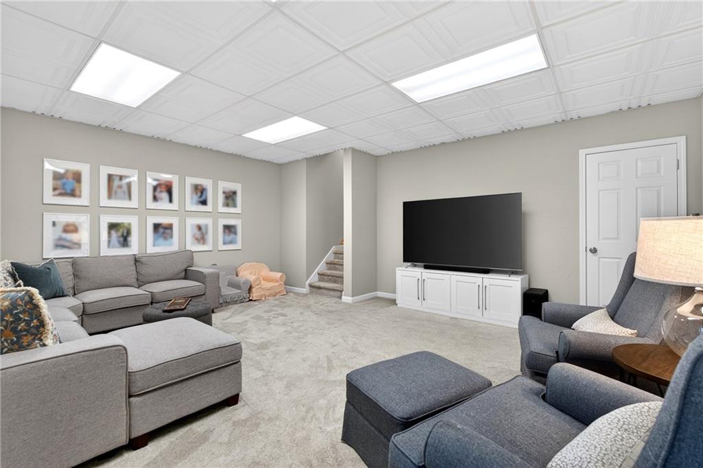 14325 Morning Mountain Way Milton, GA 30004 - Photo 38 of 66 a living room with furniture and a flat screen tv