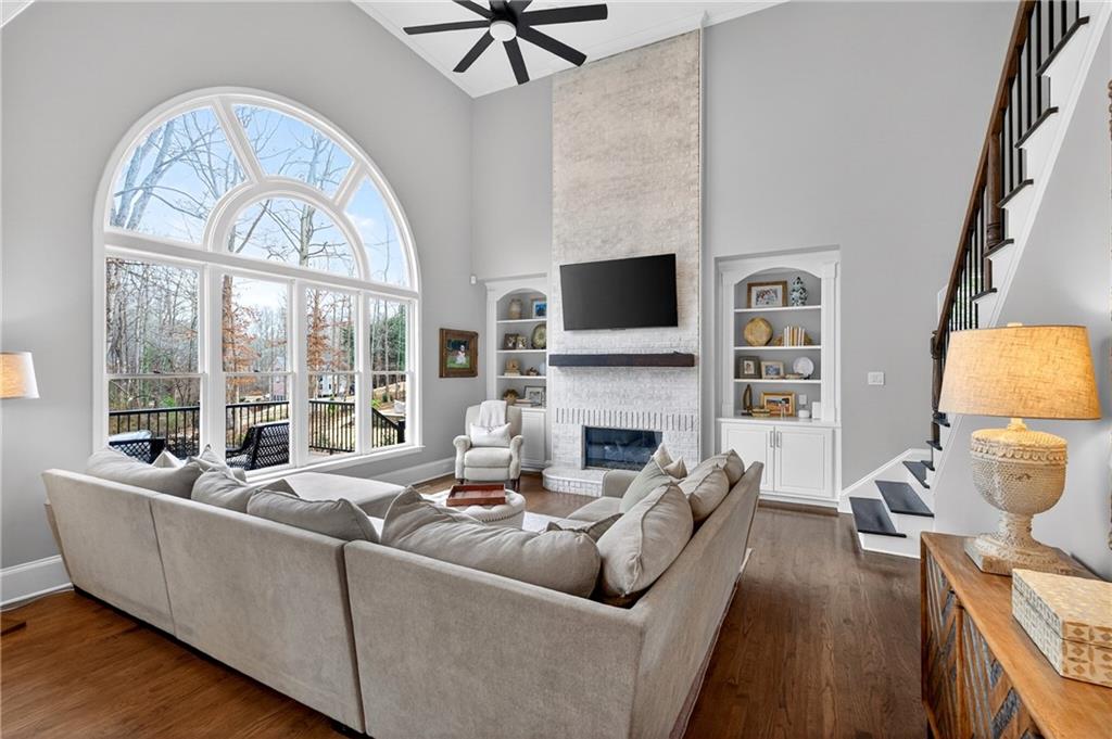 14325 Morning Mountain Way Milton, GA 30004 - Photo 4 of 66 a living room with furniture a fireplace and a flat screen tv