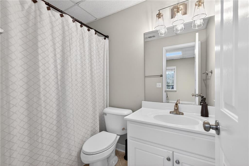 14325 Morning Mountain Way Milton, GA 30004 - Photo 41 of 66 a bathroom with a sink a toilet and shower curtain