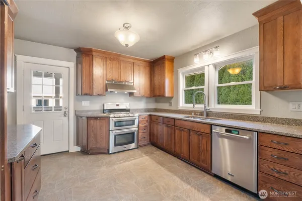 a kitchen with a sink stove and cabinets