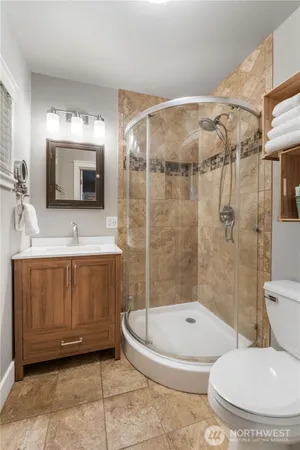 a bathroom with a toilet sink and shower
