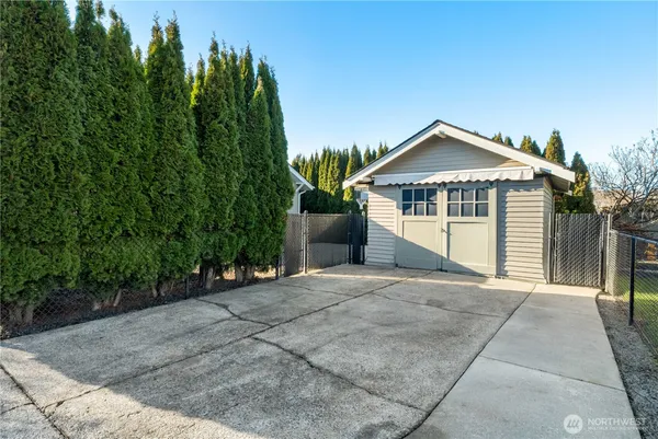 a front view of house with yard and trees around