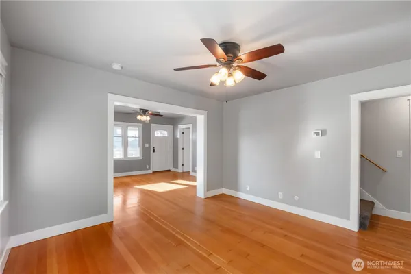 a view of empty room with wooden floor