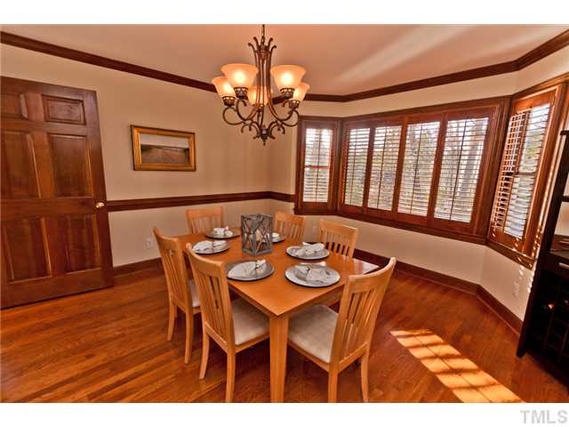 4405 Ennismore Circle Raleigh, NC 27613 - Photo 3 of 21 Dining room with hardwood floors, plantation shutters.
