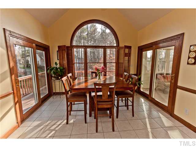 4405 Ennismore Circle Raleigh, NC 27613 - Photo 6 of 21 Breakfast room off kitchen with tile floors, plantation shutters, vaulted ceiling, doors to sun room and to deck.
