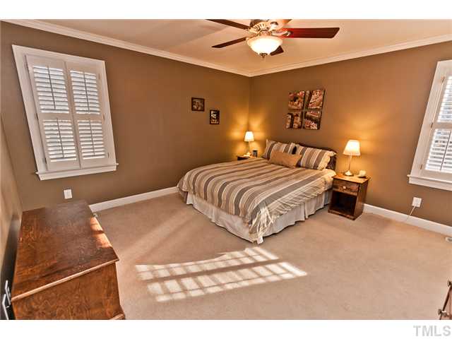 4405 Ennismore Circle Raleigh, NC 27613 - Photo 8 of 21 Downstairs master bedroom with ceiling fan and plantation shutters.