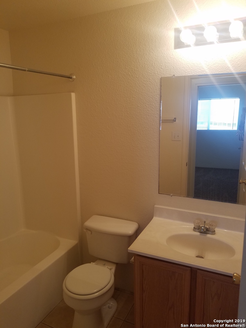 11207 Terra Loop Road San Antonio, TX 78233 - Photo 5 of 7 a bathroom with a sink a toilet and shower