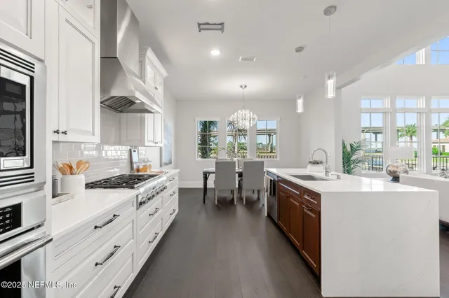 a kitchen with granite countertop a sink stainless steel appliances and cabinets