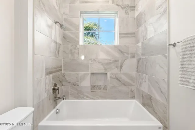 a bathroom with a double vanity sink toilet and a mirror