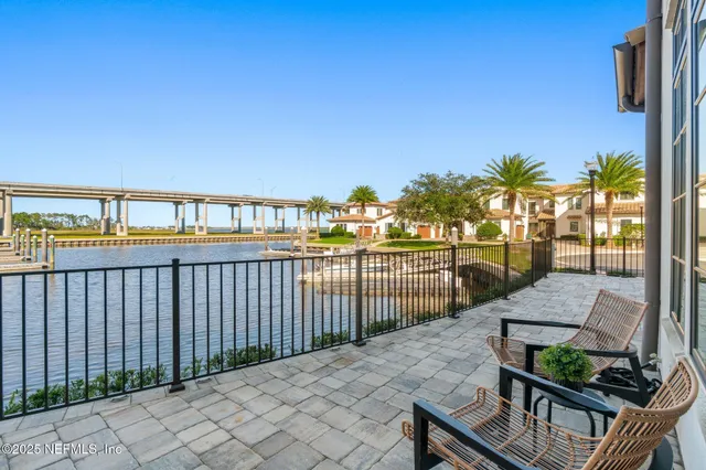 a view of a hallway with wooden floor and living room