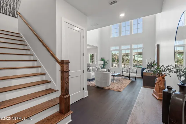 a living room with furniture and view of kitchen