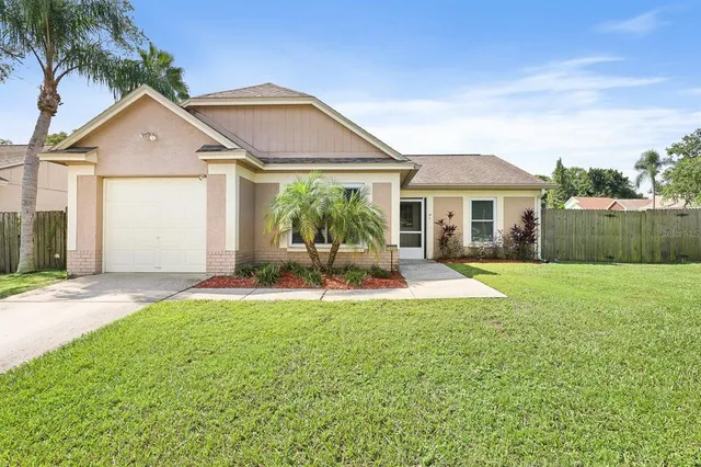 a view of a house with a yard and a porch