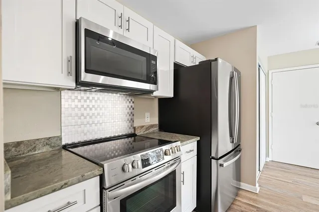 a kitchen with a stove microwave and refrigerator