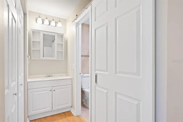 a bathroom with a sink a toilet and a window