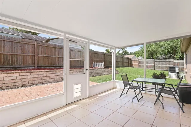 a view of a chair and tables in the back yard
