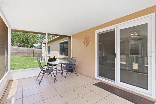 a patio with yard glass top table and chairs