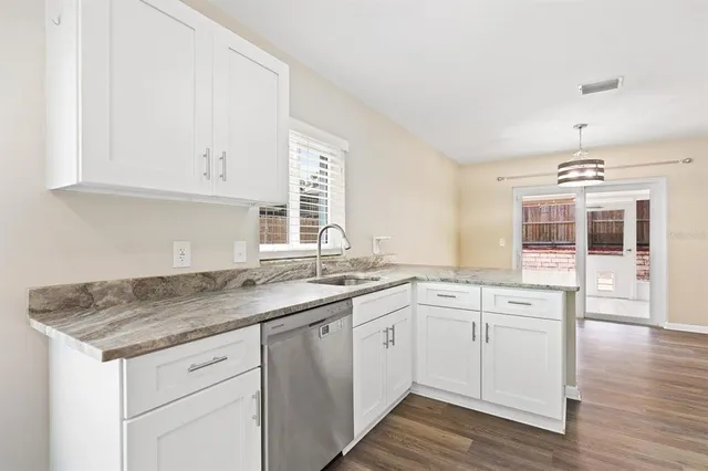 a kitchen with a sink stove and cabinets