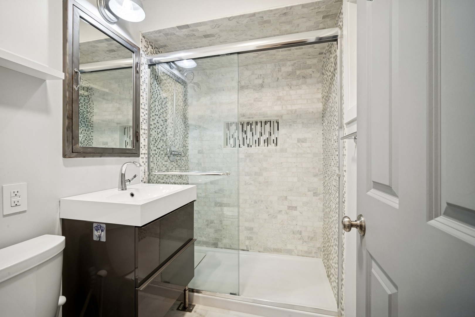 505 Pine Court Lake Bluff, IL 60044 - Photo 15 of 29 a bathroom with a sink mirror and a shower