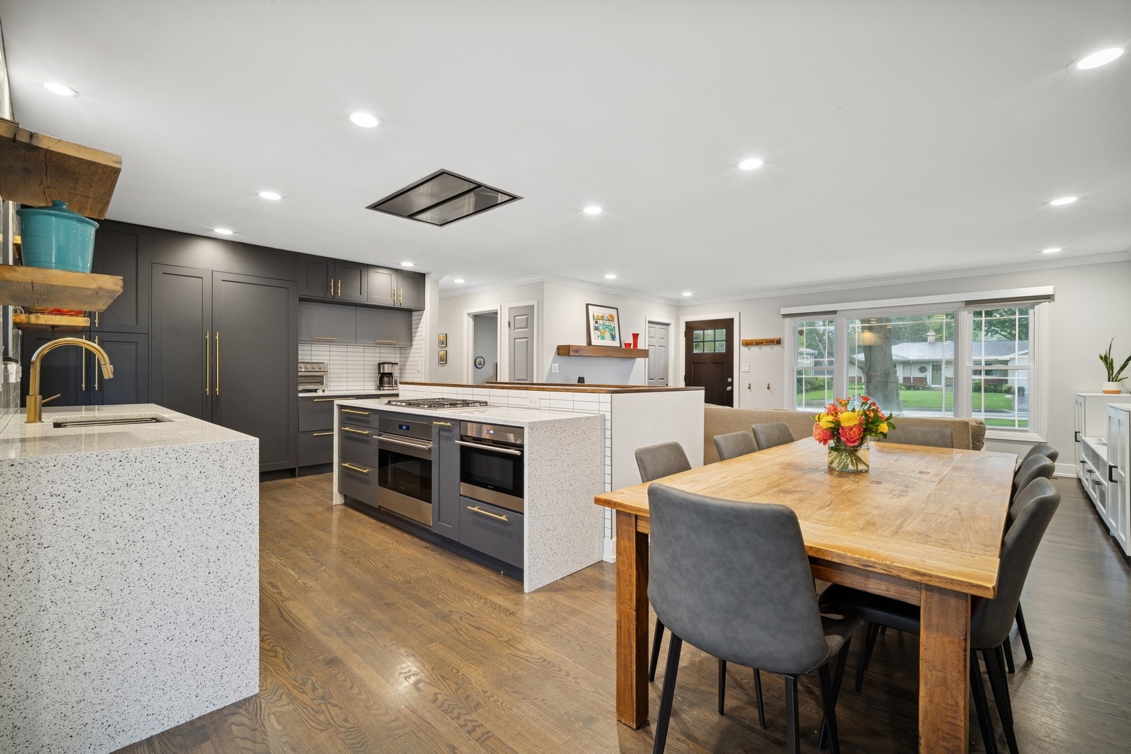 505 Pine Court Lake Bluff, IL 60044 - Photo 9 of 29 a kitchen with a stove a sink a kitchen island with chairs and wooden floor