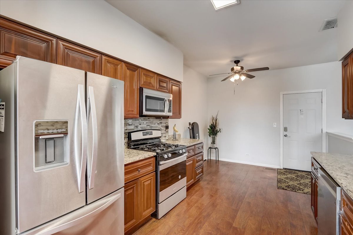 17885 Braewick Road, Unit 17217 Gurnee, IL 60031 - Photo 15 of 35 a kitchen with stainless steel appliances a refrigerator and a stove top oven