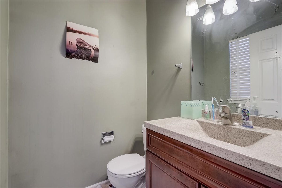 17885 Braewick Road, Unit 17217 Gurnee, IL 60031 - Photo 17 of 35 a bathroom with a granite countertop sink mirror vanity and toilet