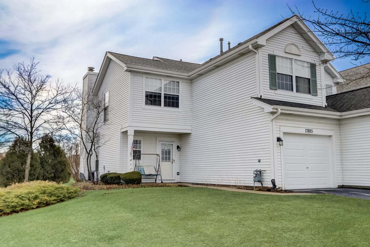 17885 Braewick Road, Unit 17217 Gurnee, IL 60031 - Photo 2 of 35 a front view of a house with a yard