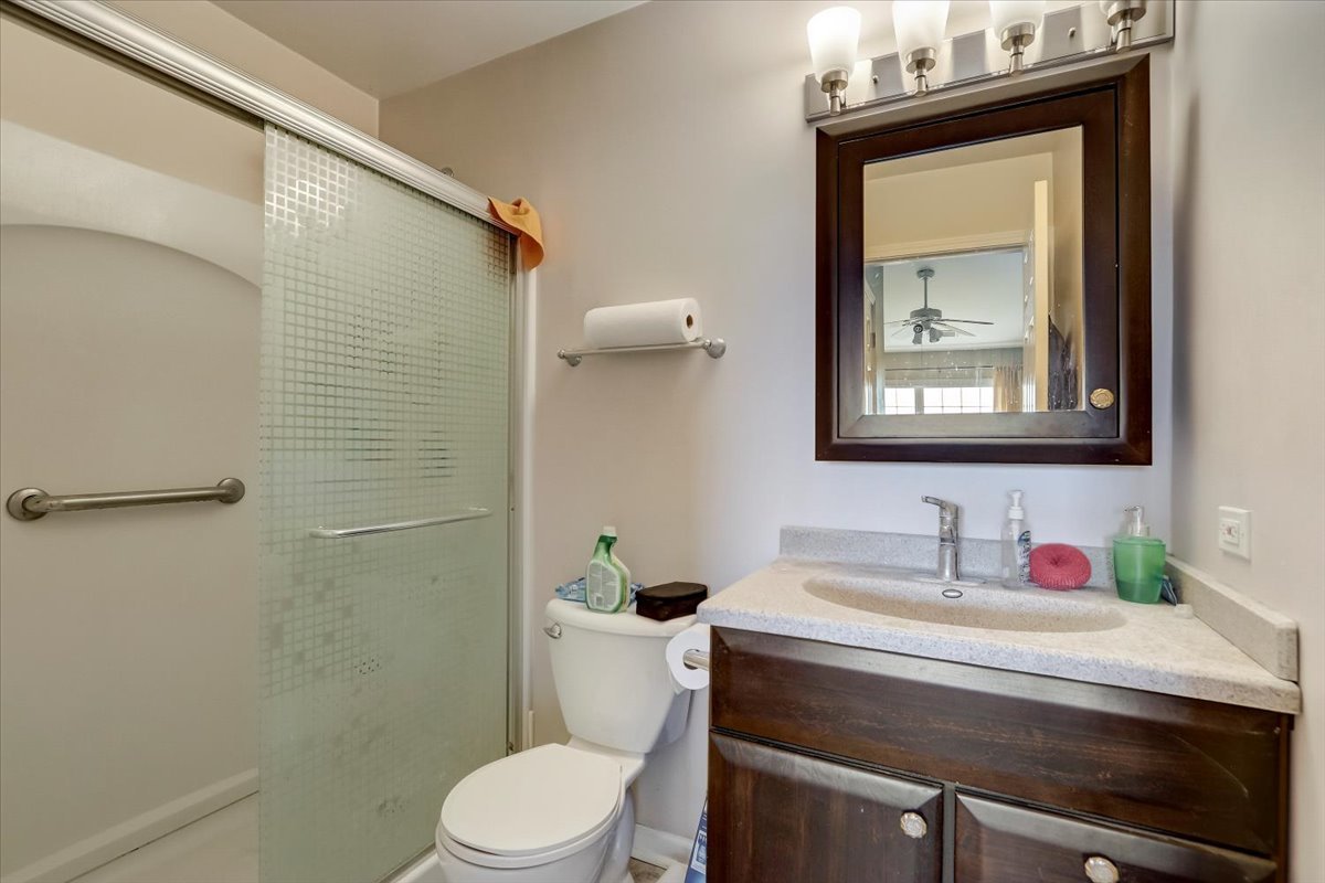 17885 Braewick Road, Unit 17217 Gurnee, IL 60031 - Photo 23 of 35 a bathroom with a toilet sink and mirror