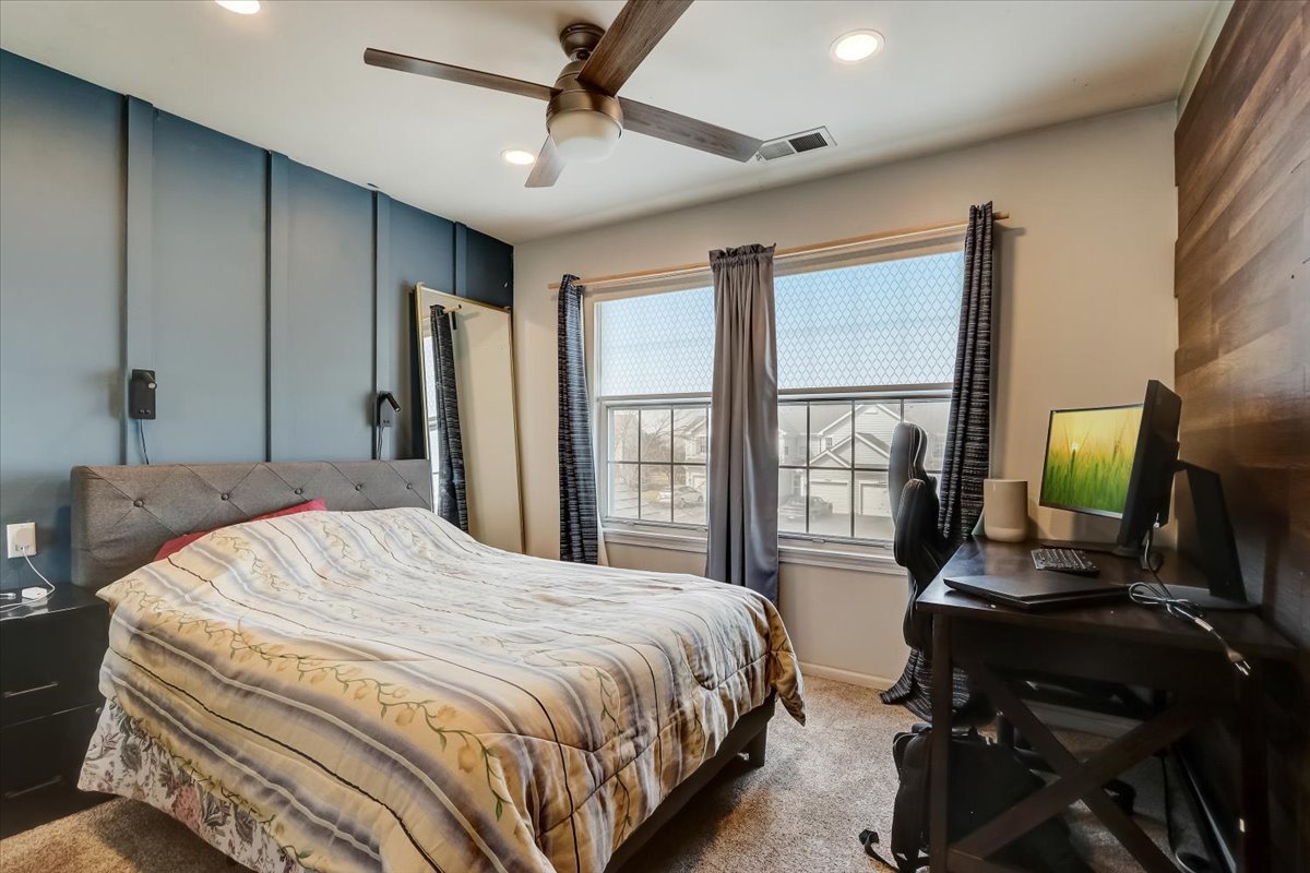17885 Braewick Road, Unit 17217 Gurnee, IL 60031 - Photo 24 of 35 a bedroom with a bed window and a flat screen tv