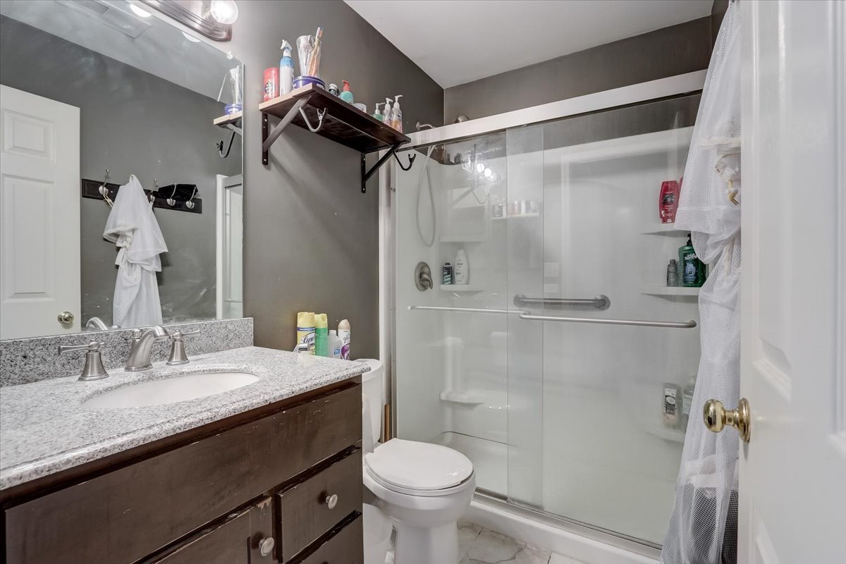 17885 Braewick Road, Unit 17217 Gurnee, IL 60031 - Photo 26 of 35 a bathroom with a sink toilet and shower