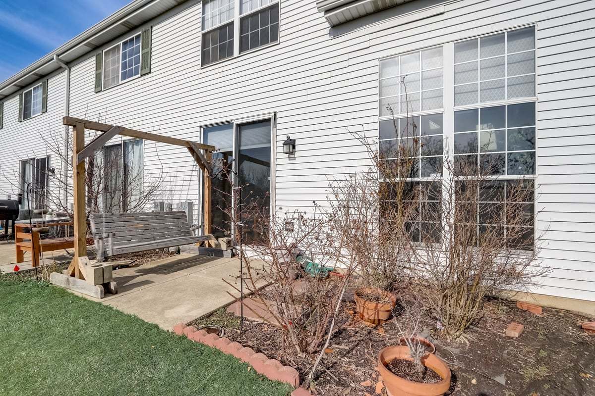 17885 Braewick Road, Unit 17217 Gurnee, IL 60031 - Photo 28 of 35 a view of a porch with a bench