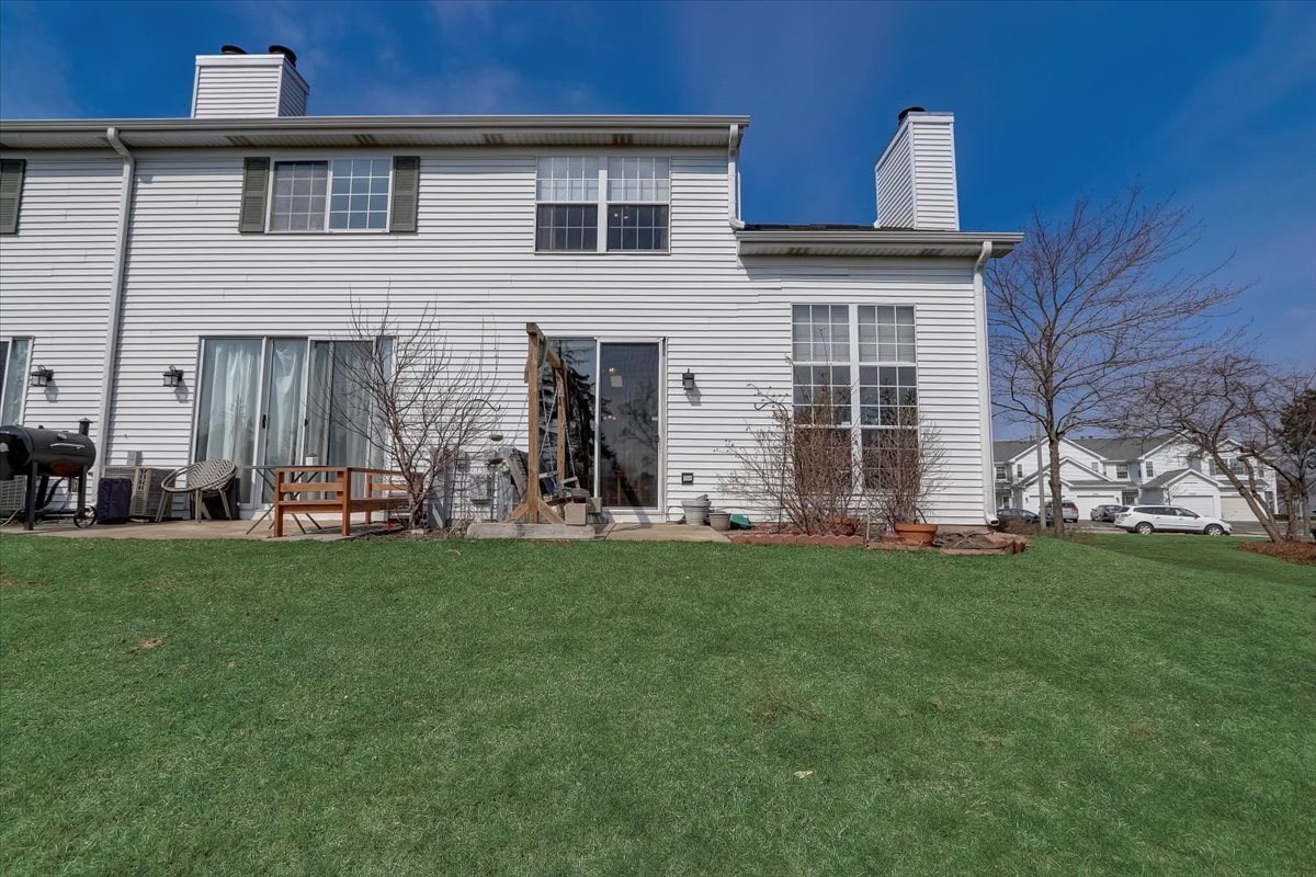 17885 Braewick Road, Unit 17217 Gurnee, IL 60031 - Photo 29 of 35 a view of a house with a backyard