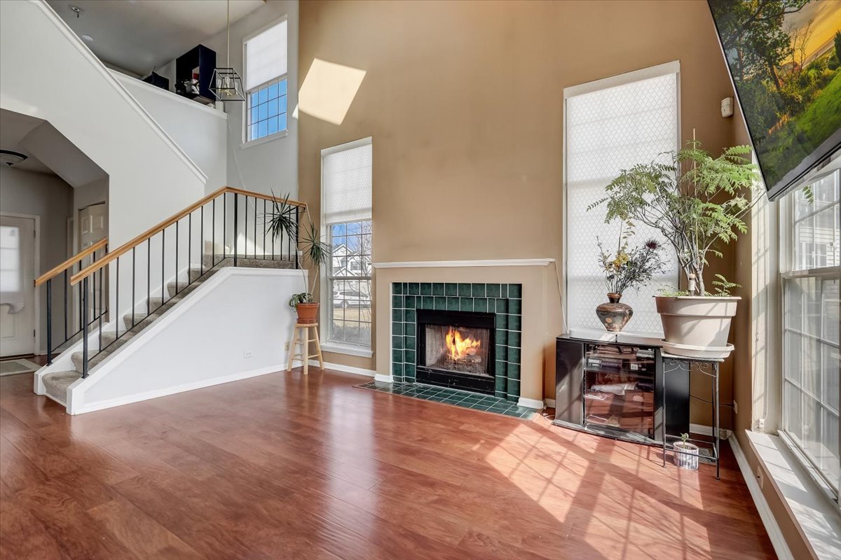 17885 Braewick Road, Unit 17217 Gurnee, IL 60031 - Photo 6 of 35 a view of an empty room with wooden floor fireplace and a window