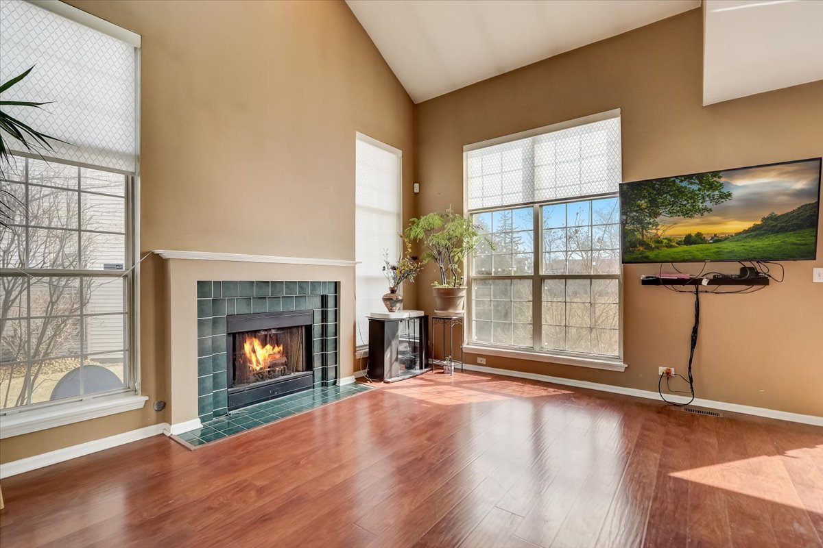 17885 Braewick Road, Unit 17217 Gurnee, IL 60031 - Photo 7 of 35 a view of an empty room with wooden floor and a window