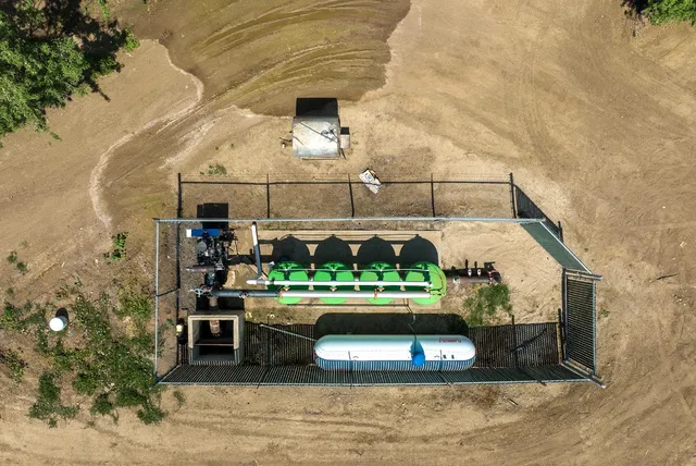 a room with lots of wooden furniture and a potted plant