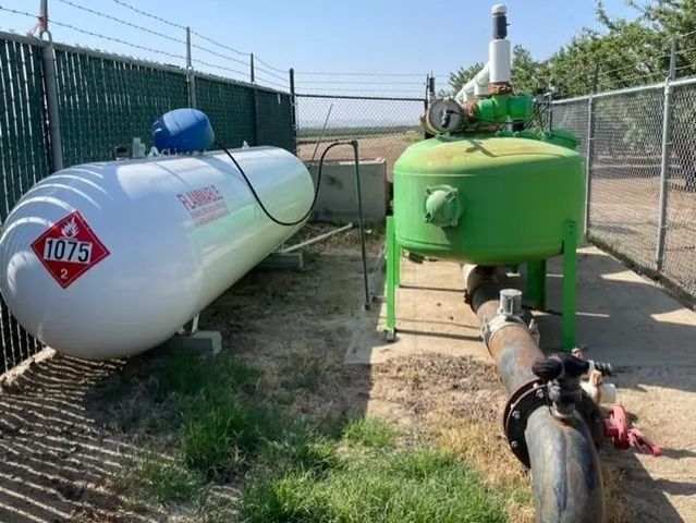 a view of a street with some trees in the background
