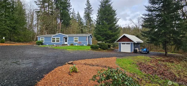 a front view of a house with a garden and yard