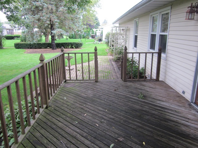 208 Linder Lane Rochelle, IL 61068 - Photo 24 of 25 a view of a deck with wooden floor and fence with a garden