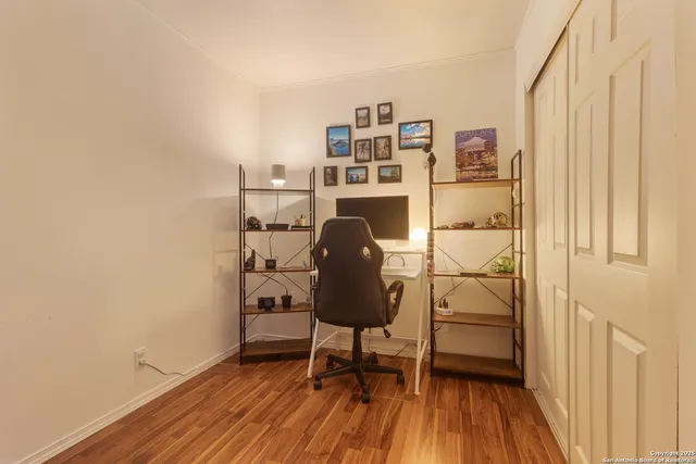 a view of a workspace with furniture and wooden floor