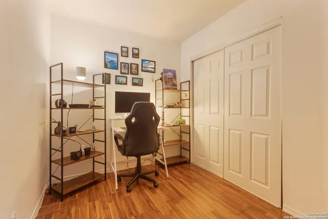 a workspace room with furniture and wooden floor