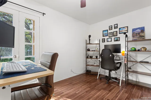 a view of a workspace with furniture and a window