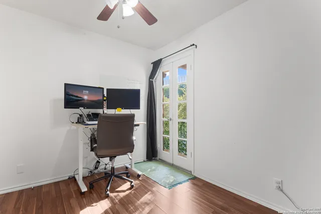 a view of a workspace with furniture and a window